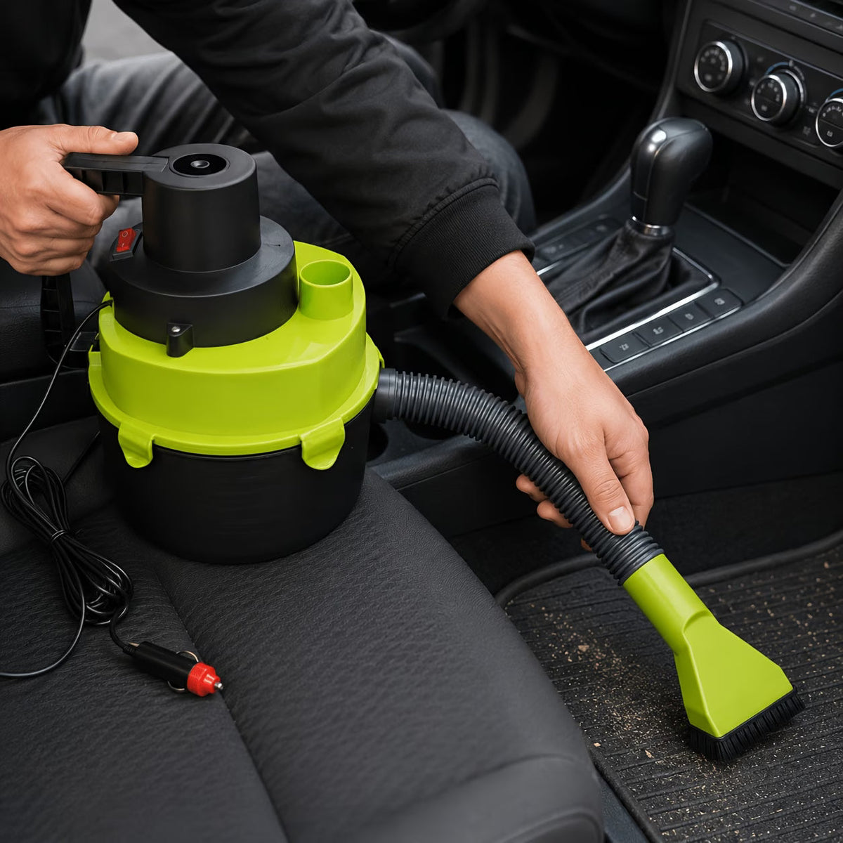 Handheld car vacuum cleaner being used to clean car seat with flexible hose and brush nozzle